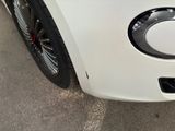 a close up of a white car with a black rim