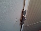 a close up of a door handle on a white door