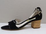 a pair of women ' s shoes with a bow on the heel