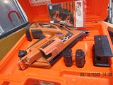 an orange box with a stapler and other tools in it
