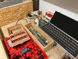 a laptop computer sitting on top of a workbench