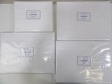 several white boxes are stacked on top of each other on a table