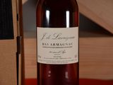 a bottle of wine sitting on a table next to a box