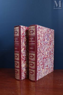 two books sitting on top of a wooden table next to a blue wall