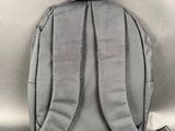 the back of a gray backpack with a strap on it