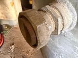a close up of a pipe with a hose attached to it