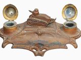 an old brass plate with a tank on it