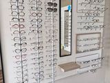 many glasses on display in a store with a mirror