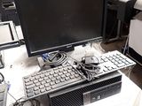 a computer sitting on a table with a keyboard and mouse
