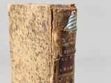 an old book sitting on top of a wooden table