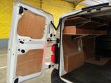 a white van with its doors open in a garage