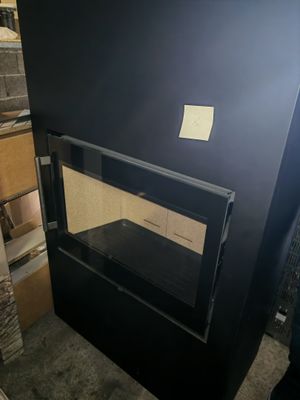 a black stove that is in a room with boxes