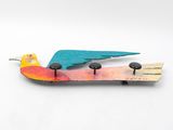 a bird that is sitting on top of a skateboard