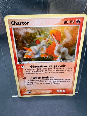 a pokemon card in a plastic holder on a table