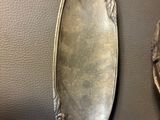two silver spoons sitting next to each other on a table