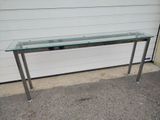 a glass table with a metal frame and a glass top