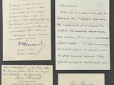 several old letters are on display on a black surface