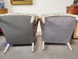pair of upholstered lounge chairs with upholstered cushions
