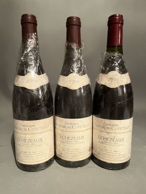 three bottles of wine sitting on top of a table next to each other