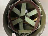 an overhead view of a military helmet with a green ribbon around it