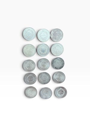 several pieces of metal are arranged on a white surface