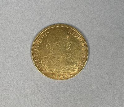 a gold coin on a white surface
