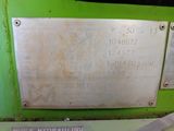 a metal plaque on the side of a green machine