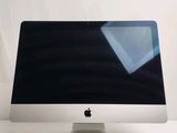 a computer monitor sitting on top of a white table