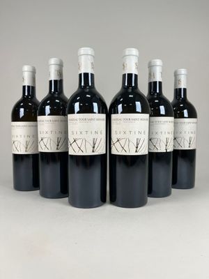 six bottles of wine are lined up in a row on a table