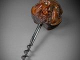 a close up of a bottle opener with a face on it