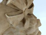 statue of a woman wearing a hat with a bow on top of her head