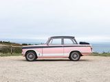 a pink and black car parked on the side of the road