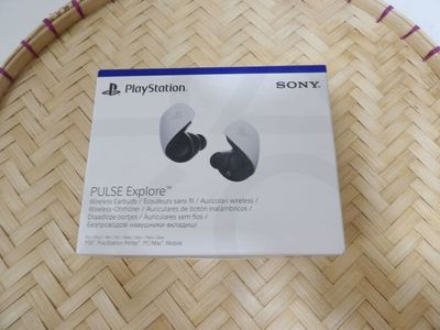 packaging for the sony earphones is shown on a woven basket