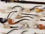 many different types of pipe holders and pipes on the table