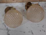 two glass lamps sitting on a marble counter top