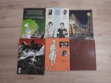several books on a wooden floor with a picture of a man and a woman