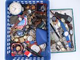 a blue basket filled with assorted watches and other items
