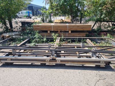 a lot of wood on the ground in the middle of the yard