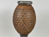 a brown vase with a silver lid on a table