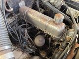 a rusted engine in the middle of a dirty car