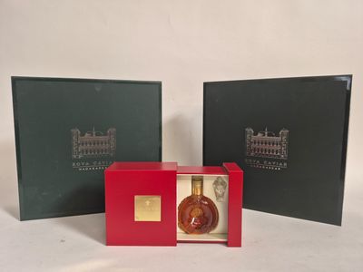two boxes with a bottle of liquor inside of them on a white surface