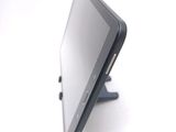 a tablet computer sitting on a stand on a white surface