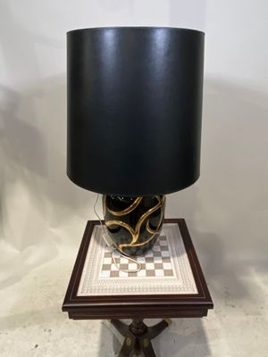 a table with a lamp on top of it on a table
