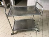 a metal cart with two trays on it in a kitchen