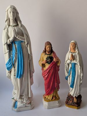 three figurines of jesus, mary, and jesus on a white background