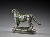 bronze statue of a lion standing on a rock