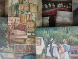 many paintings that are on display on the table
