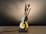 a glass sculpture of a violin on a table