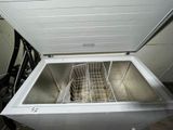 a white chest freezer with a basket inside of it