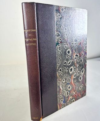 an old book sitting on top of a white table next to a white wall